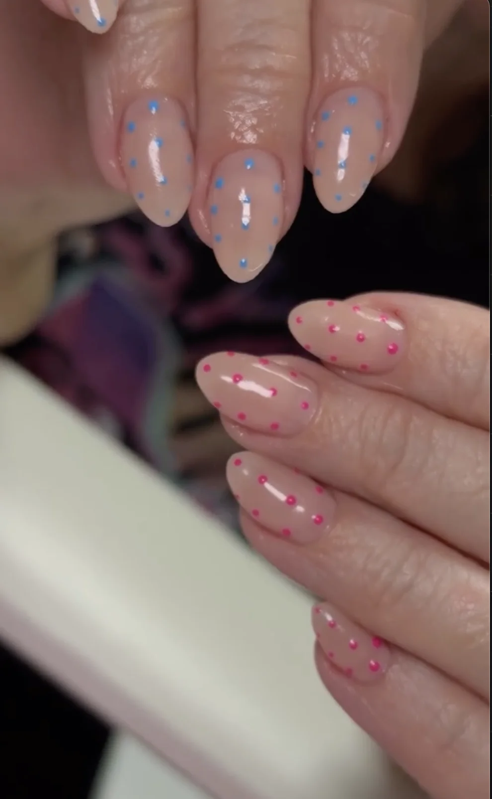 Nude nails with blue and pink polka dots after transformation