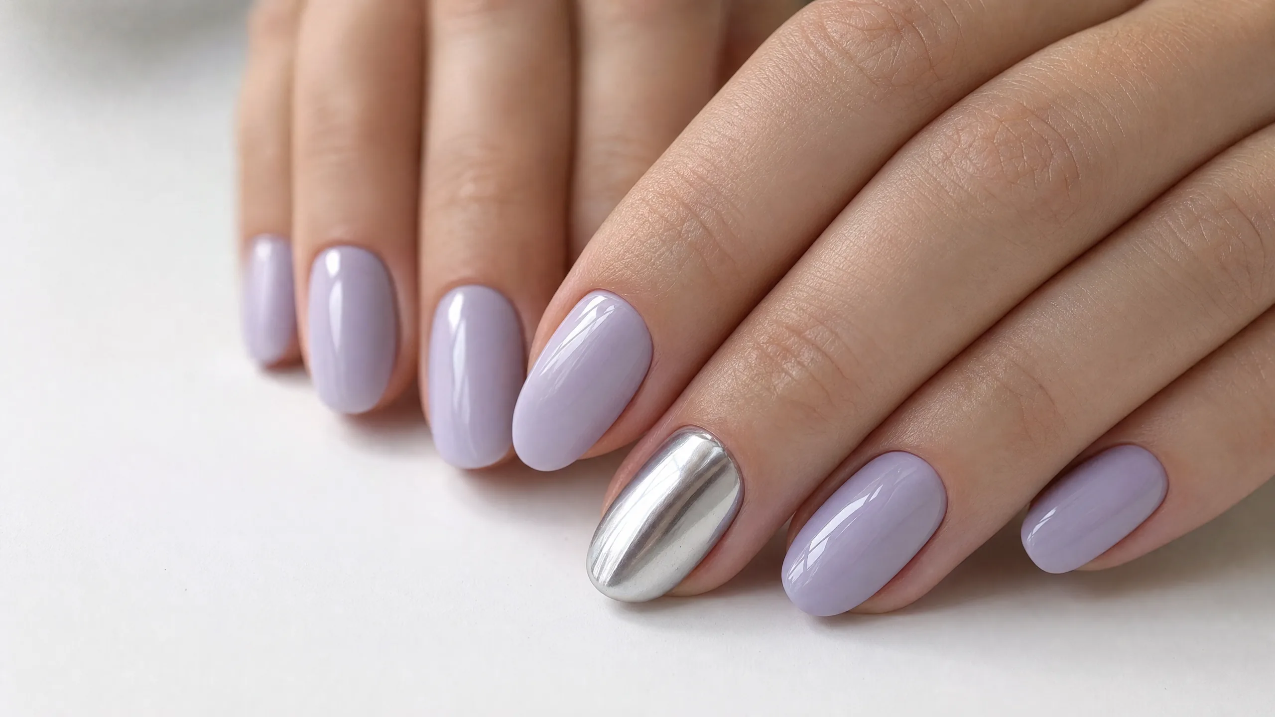 Lavender and lilac nails — soft purple shades with silver chrome accent