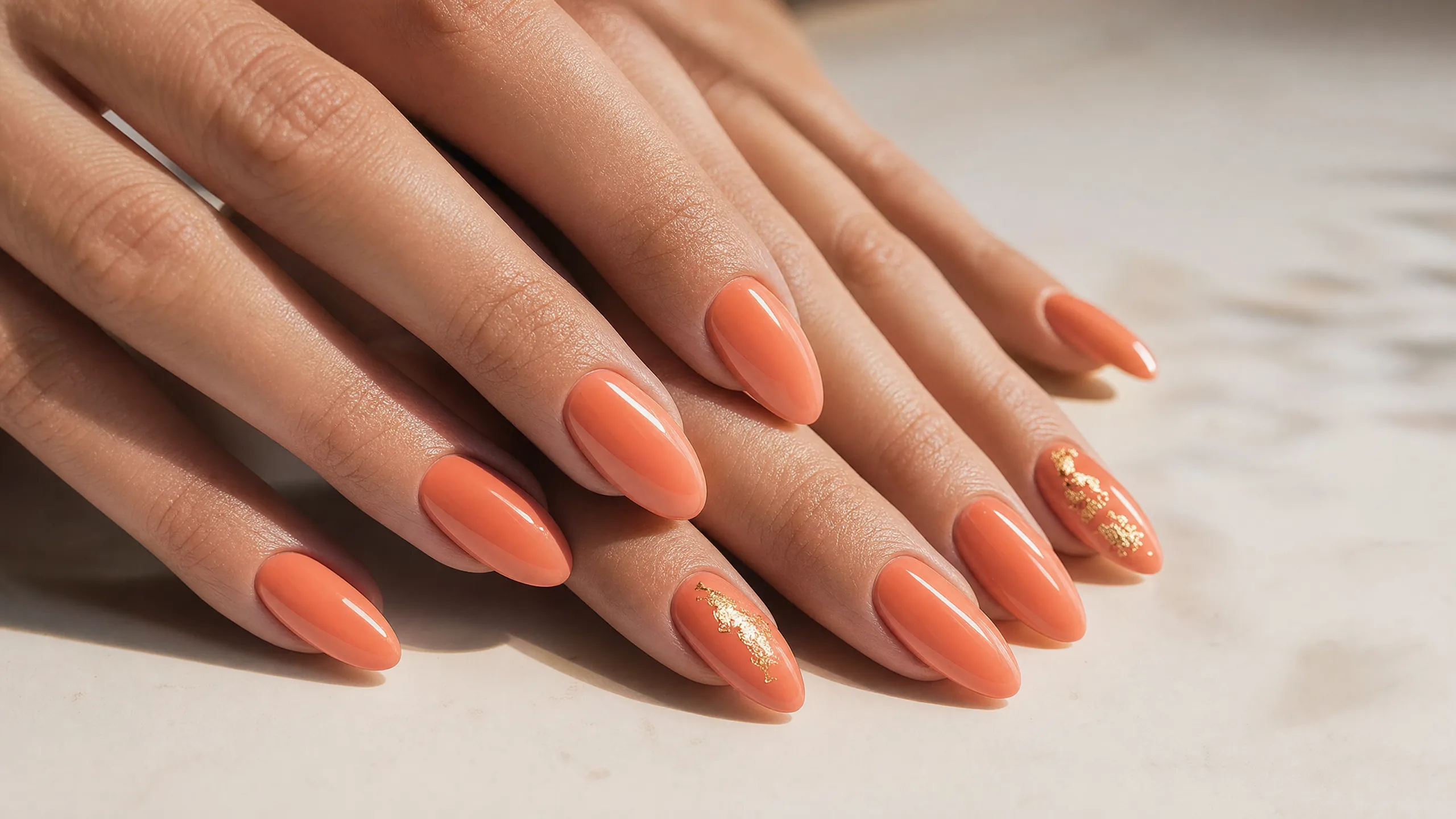 Sunset coral nails — warm peachy-coral shade perfect for summer 2026