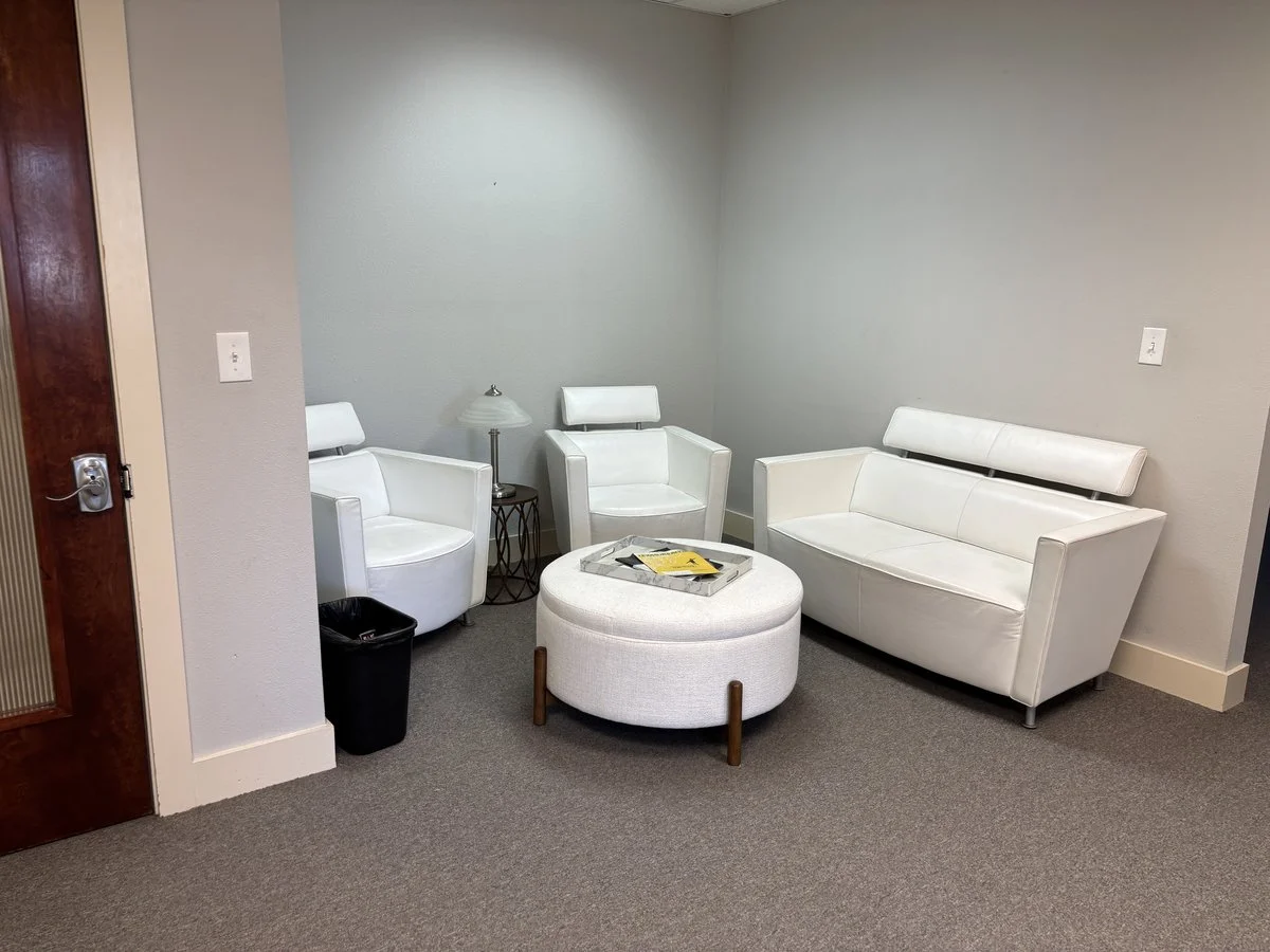 Polished by Kim private waiting area with modern white furniture in Spring, TX